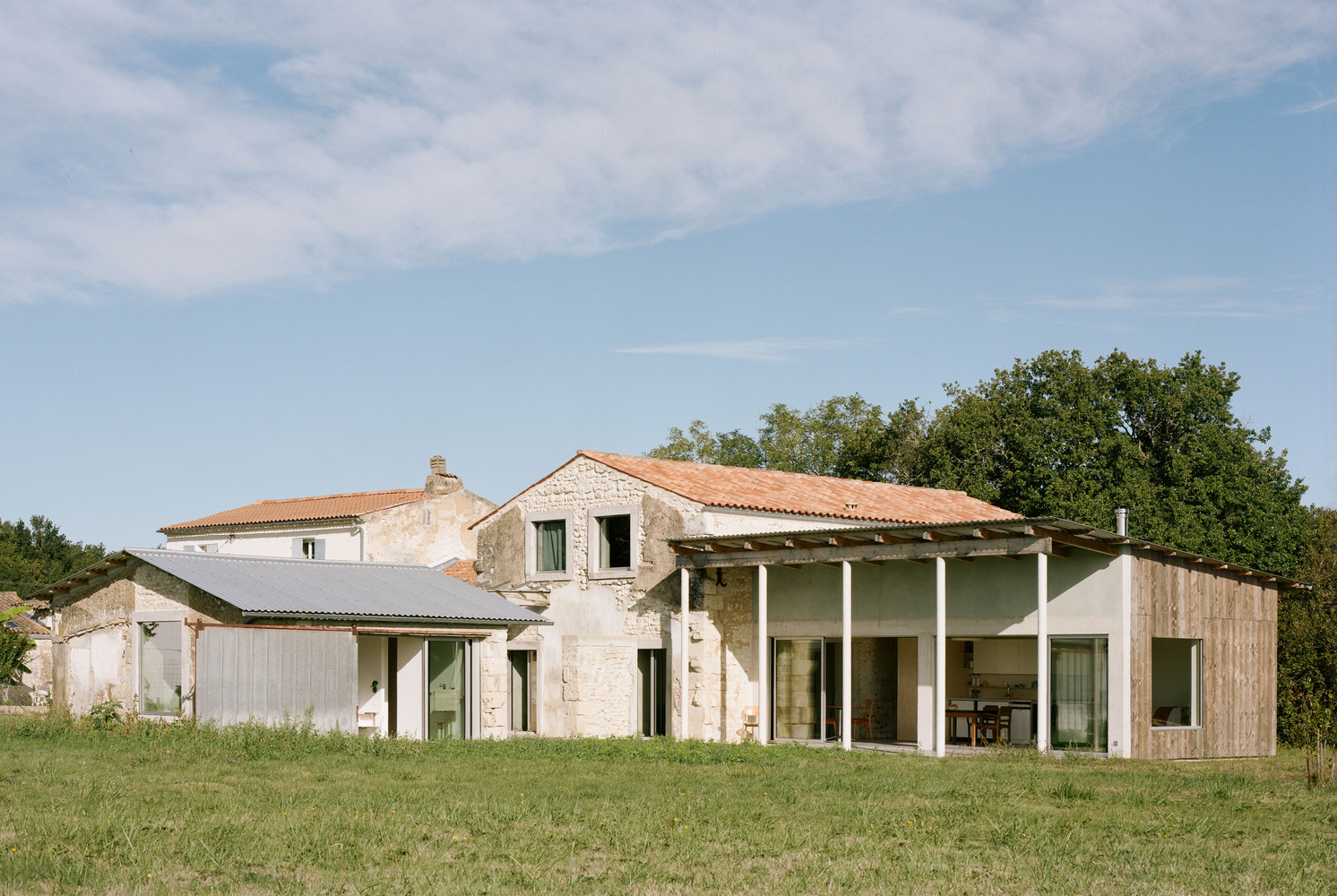 Vista exterior del conjunto de la transformación de un granero en una casa de vacaciones en Francia de Migeon Architecture. 